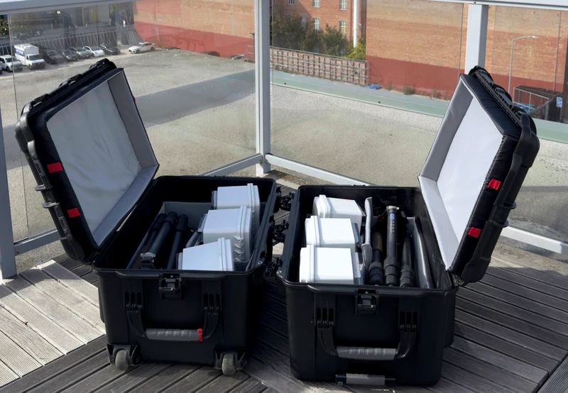 Two open Soundryx Flyaway Kit cases containing sensors and tripods